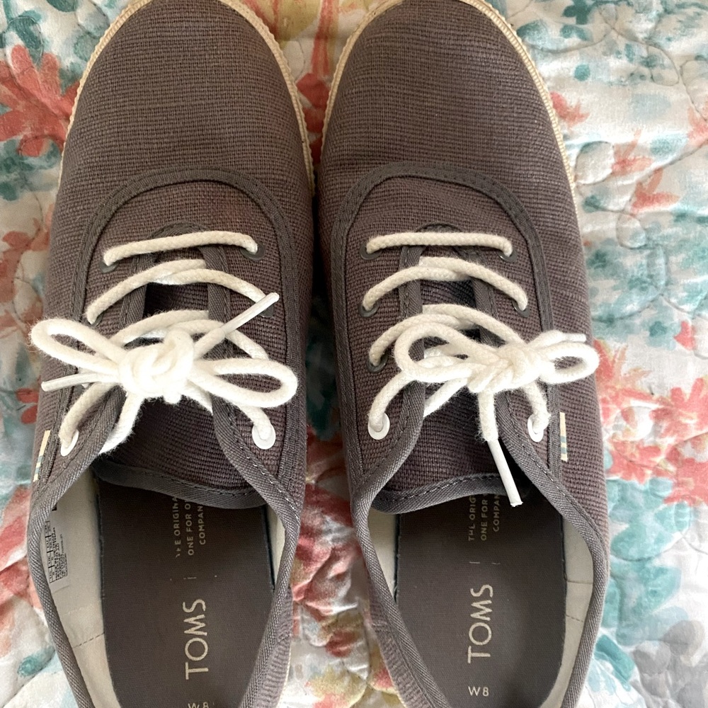 Toms flat tennis shoes.